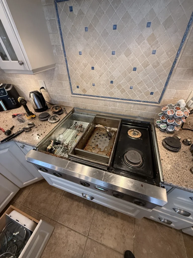 Gas rangetop: Burner box opened for valve and wiring repair